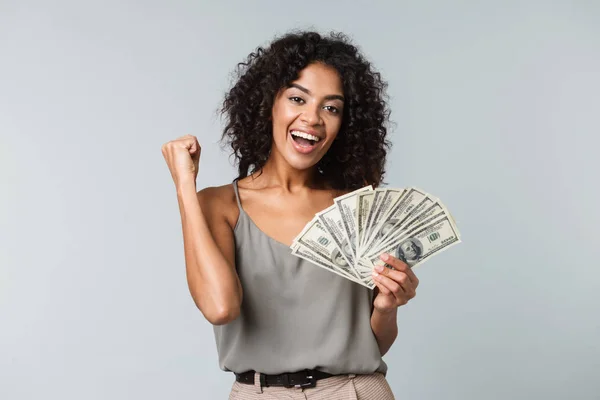 Happy woman holding money for loan comparison